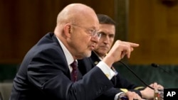 Director of National Intelligence James Clapper (l) accompanied by DIA Director Lt. Gen. Michael T. Flynn, testifies on Capitol Hill, April 18, 2013.