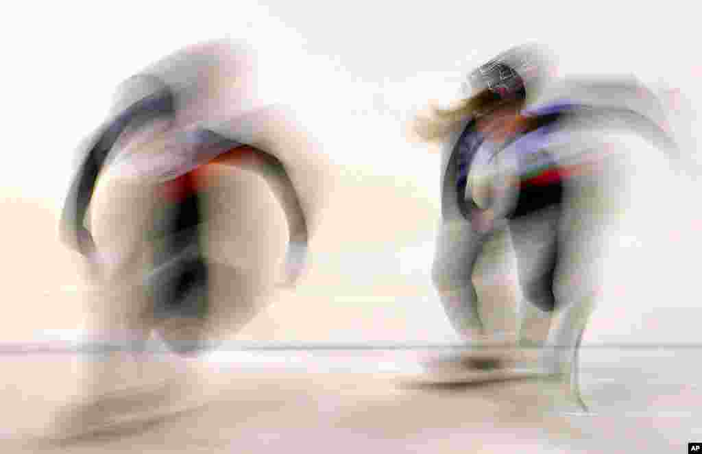 In this picture taken with a long time exposure, athletes start during the mixed 2000m relay during the World Cup short track speed skating championship in Dresden, eastern Germany.