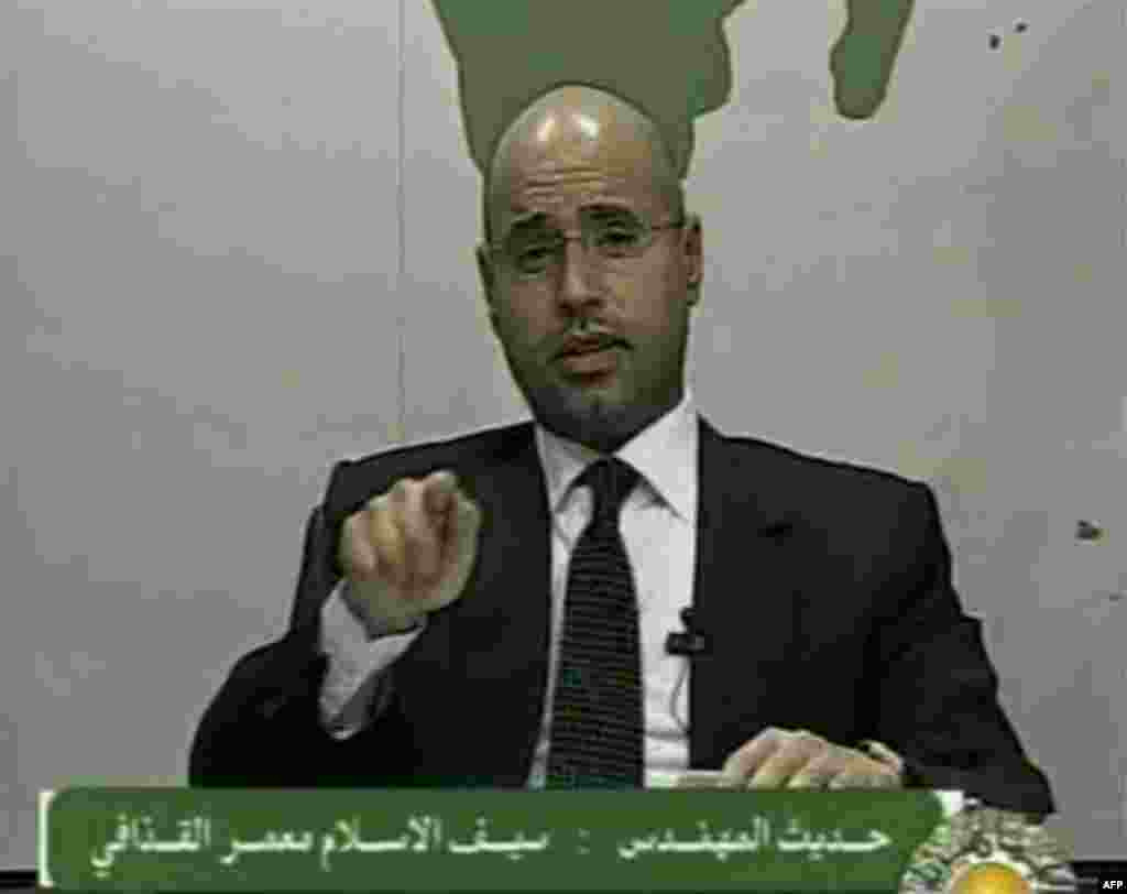 In this video image broadcast on Libyan state television early Monday Feb. 21, 2011 Seif al-Islam, son of longtime Libyan leader Moammar Gadhafi, speaks. Al-Islam says protesters have seized control of some military bases and tanks, and also warned of civ