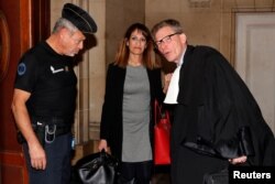 Nathalie Haddadi, who sent money to her radicalised son who fought in Syria, arrives at court with her lawyer, Paris, France, Sept. 28, 2017.