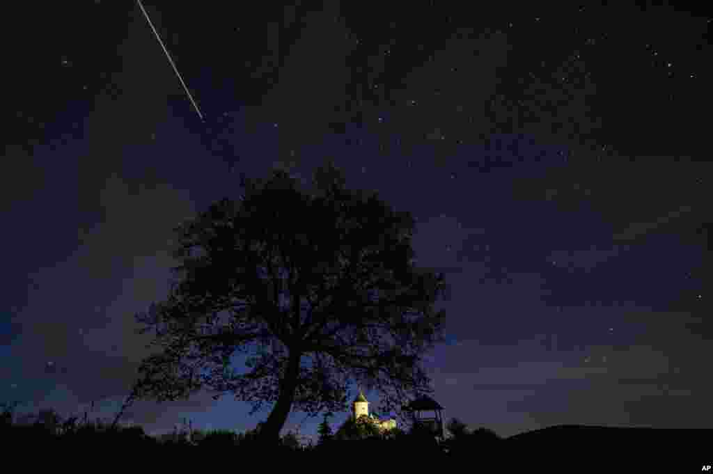 The International Space Station (ISS) moves across the sky above Somosko Castle near Salgotarjan, Hungary, in this long exposure photograph.