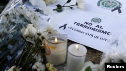 A sign that reads "No to terrorism, Colombia is in mourning" is seen in front of the scene where a car bomb exploded, in Bogota, Colombia, Jan. 18, 2019.