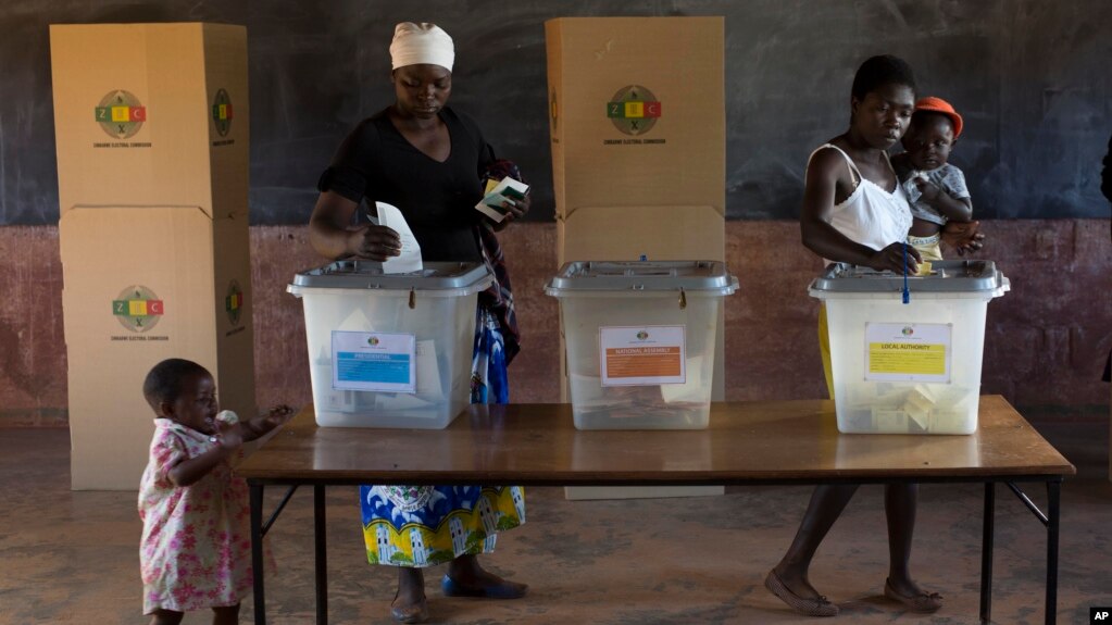 FILE: Zimbabweans vote at the Sherwood Primary School in Kwekwe, Zimbabwe, Monday July 30, 2018. The vote will be a first for the southern African nation following a military takeover and the ousting of former longterm leader Robert Mugabe. (AP Photo/Jerome Delay)