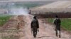 FILE - Turkish soldiers patrol near the border with Syria, outside the village of Elbeyli, east of the town of Kilis, southeastern Turkey, July 24, 2015.