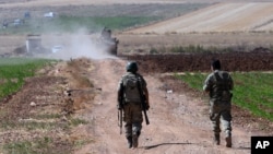 FILE - Turkish soldiers patrol near the border with Syria in southeastern Turkey, July 24, 2015.