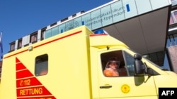 An ambulance carrying onboard a patient infected with the Ebola virus arrivres at the Universitaetsklinikum Hamburg Eppendorf (UKE) university hospital in Hamburg, northern Germany, August 27, 2014.