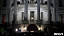 U.S. President Barack Obama (silhouetted in car window) and his family return after his re-election, to the White House in Washington, November 7, 2012. 