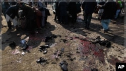 People help clear casualties from the site of a suicide attack at a Shi'ite Muslim gathering in Kabul, December 6, 2011.