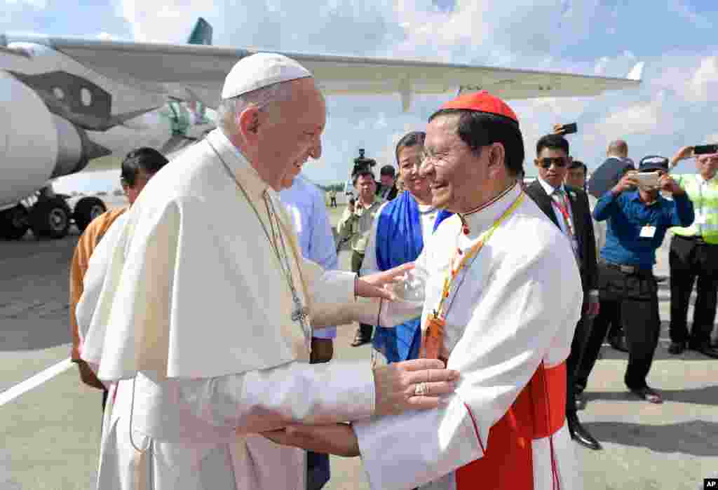 Pope Francis is welcomed by Cardinal Charles Maung Bo upon his arrival at the airport in Yangon, Myanmar, Nov. 27, 2017. The pontiff is in Myanmar for the first stage of a week-long visit that will also take him to neighboring Bangladesh.