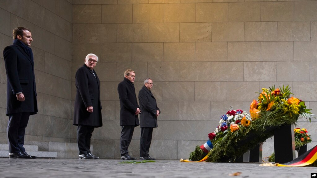 France's President Emmanuel Macron and German President Frank-Walter Steinmeier attend a wreath laying ceremony at the Central Memorial for the Victims of War and Dictatorship in Berlin, Nov. 18, 2018.