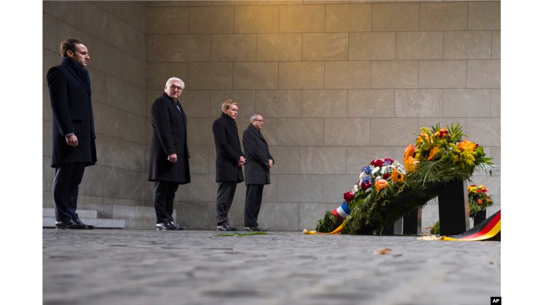 France's President Emmanuel Macron and German President Frank-Walter Steinmeier attend a wreath laying ceremony at the Central Memorial for the Victims of War and Dictatorship in Berlin, Nov. 18, 2018.
