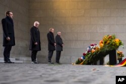 France's President Emmanuel Macron and German President Frank-Walter Steinmeier attend a wreath laying ceremony at the Central Memorial for the Victims of War and Dictatorship in Berlin, Nov. 18, 2018.