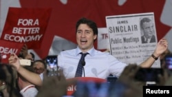 Liberal leader Justin Trudeau reacts during a campaign rally in North Vancouver, British Columbia, October 18, 2015.