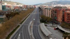 An empty avenue in Barcelona, Spain, Sunday, March 15, 2020. Spain's government announced Saturday that it is placing tight restrictions on movements and closing restaurants and other establishments in the nation. (AP Photo/Joan Mateu)