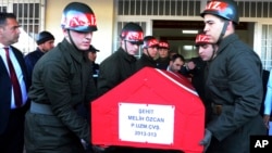 Soldiers at the airport in Gaziantep, Turkey, carry the coffin of a Turkish soldier killed in what the Turkish military said was a pre-dawn airstrike carried out by Syrian government forces, Nov. 24, 2016.