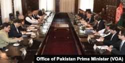 FILE - Pakistan Prime Minister Shahid Khaqan Abbasi and Afghan President Ashraf Ghani lead their respective delegations in formal talks, April 6, 2018, in the presidential palace in Kabul.