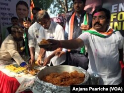 Congress Party workers distribute sweets as Rahul Gandhi, the fourth generation of the powerful Nehru Gandhi political dynasty, emerged at the helm of the party.