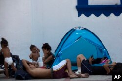 Central American migrants traveling in a caravan to the U.S. rest in the San Francisco Catholic church in Tonala, Chiapas State, Mexico, April 23, 2019.