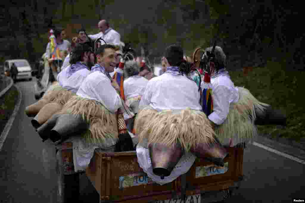 Dancers are transported in a trailer during carnival celebrations in Ituren, Spain, Feb. 1, 2016. Bell carrying dancers known as Joaldunak from Zubieta and neighboring Ituren visit each other&#39;s villages performing a ritual dance to ward off evil spirits and awaken the coming spring.