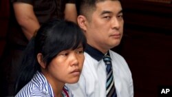 FILE - Philippine national Mary Jane Veloso, left, who is on death row for drug offences, accompanied by an unidentified interpreter, attends her judicial review hearing at Sleman District Court in Yogyakarta, Indonesia, March 4, 2015.