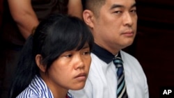 FILE - Philippine national Mary Jane Fiesta Veloso, left, who is on death row for drug offences, accompanied by an unidentified interpreter, attends her judicial review hearing at Sleman District Court in Yogyakarta, Indonesia, March 4, 2015.