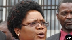 Zimbabwean Deputy President, Joice Mujuru talks to the press outside the magistrates courts in Harare, Monday, Feb. 6, 2012
