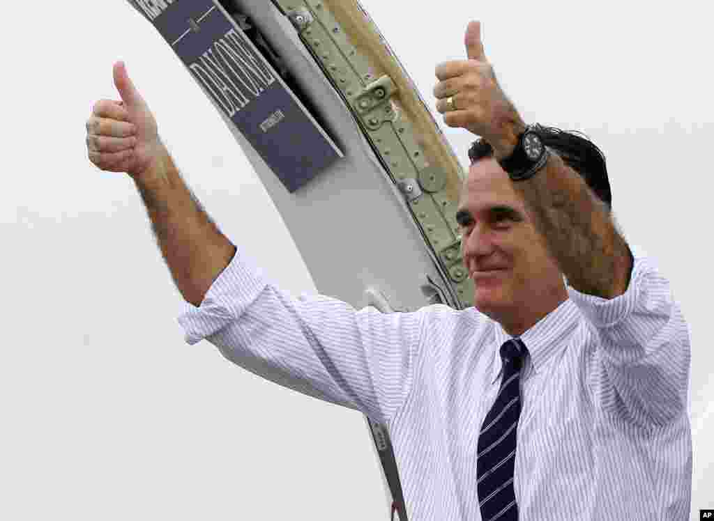 Republican presidential candidate, former Massachusetts Gov. Mitt Romney gives two thumbs up as he boards his campaign plane to head to Virginia after a Florida campaign rally in Sanford, Nov. 5, 2012. 