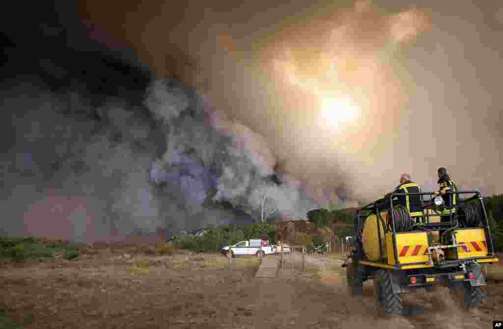 Firemen fight a blaze in the Kranshoek area in South Africa, June 7, 2017.