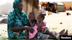Malian family displaced by war gather at a makeshift camp in Sevare, about 400 miles northeast of Bamako, July 11, 2012.
