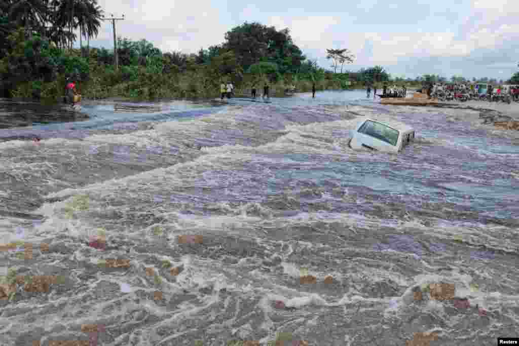 Vast stretches of Nigeria were hit by floods. Flood waters submerge a vehicle in the Patani community in Nigeria&#39;s Delta State, October 2012. 