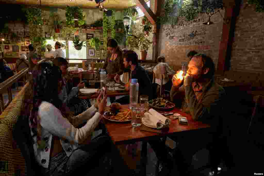 People smoke at Lowell Farms, America&#39;s first official Cannabis Cafe offering farm-to-table dining and smoking of cannabis in West Hollywood, California, Oct. 1, 2019.