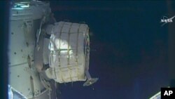 In this frame from NASA TV, a new experimental room at the International Space Station partially inflates Thursday, May 26, 2016. NASA released some air into the experimental inflatable room, but put everything on hold when problems cropped up.