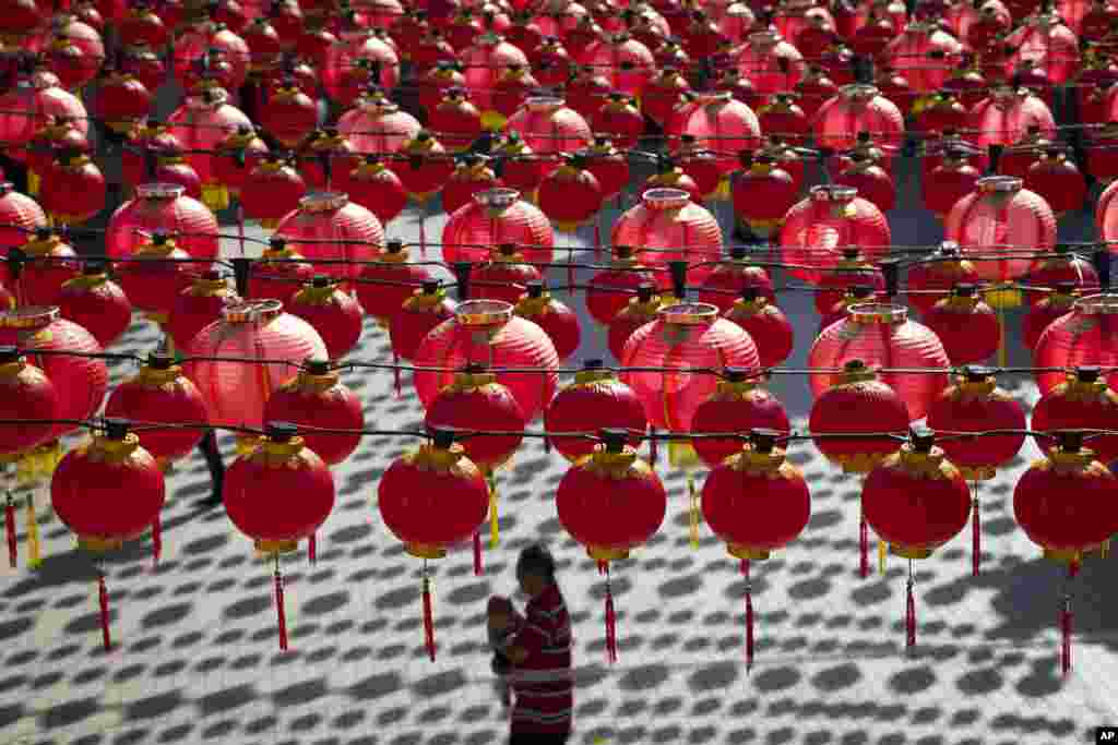 A man walks with his child under traditional Chinese lanterns on display ahead of Lunar New Year celebrations at a temple in Kuala Lumpur, Malaysia.