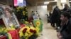 A man reacts next to portrait of Sakine Cansizt inside the Kurdish cultural center in Paris, France, January 10, 2013.