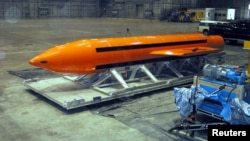 A Massive Ordnance Air Blast (MOAB) weapon is prepared for testing at the Eglin Air Force Armament Center on March 11, 2003.