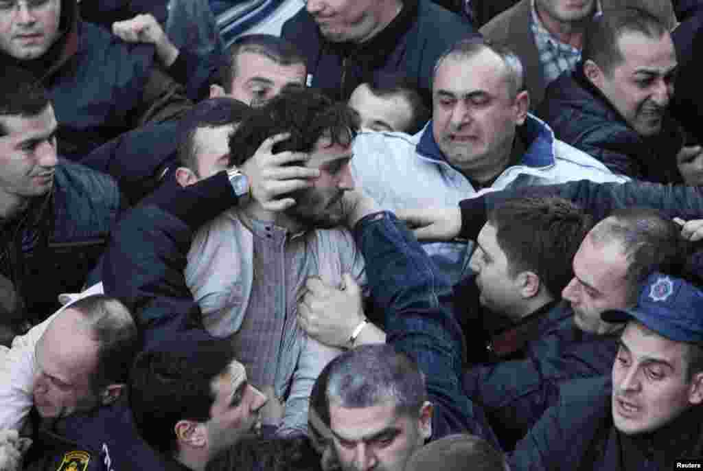 Protesters scuffle outside the National Library in the Georgia capital Tbilisi. Hundreds gathered there in an attempt to block President Mikheil Saakashvili from entering the building to deliver his last annual address to the nation.