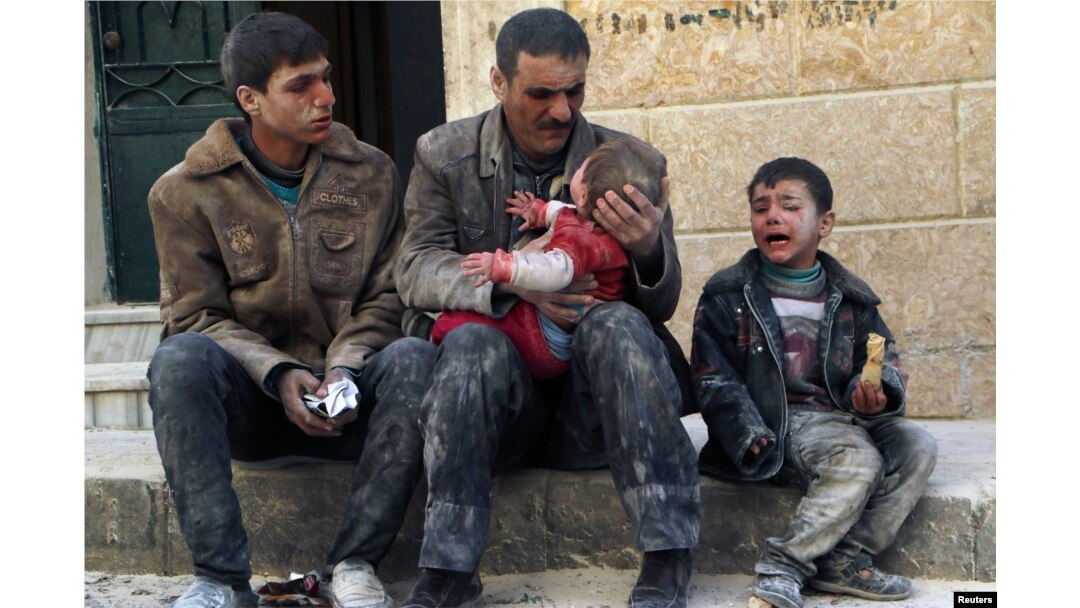 FILE - A man holds a baby who survived what activists say was an airstrike by forces loyal to Syrian President Bashar al-Assad in Masaken Hanano in Aleppo, Feb. 14, 2014.
