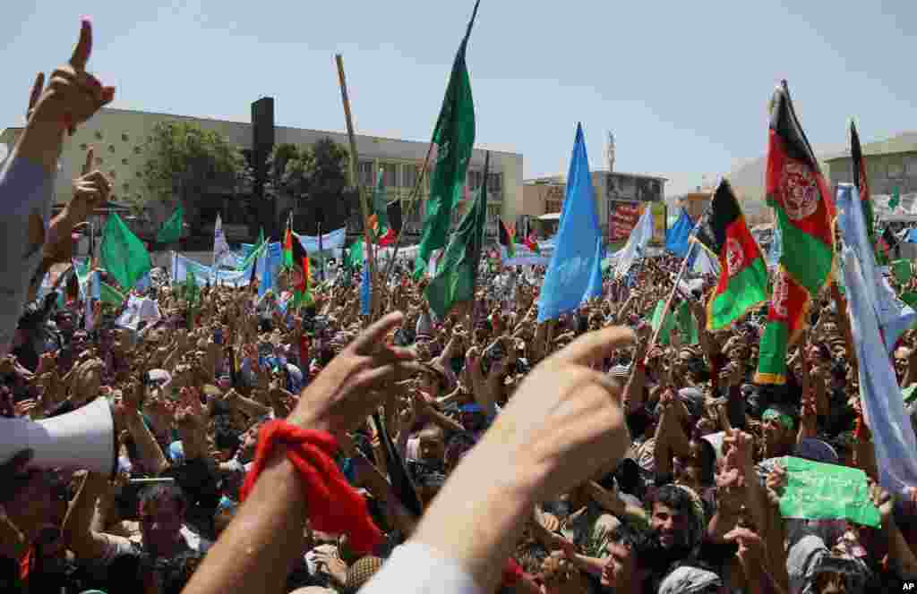 Supporters of Afghan presidential candidate Abdullah Abdullah chant slogans during a protest in Kabul, June 27, 2014.