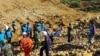 Soldiers carry the bodies of miners killed by a landslide in a jade mining area in Hpakhant, in Myanmar's Kachin state, Nov. 22, 2015. 