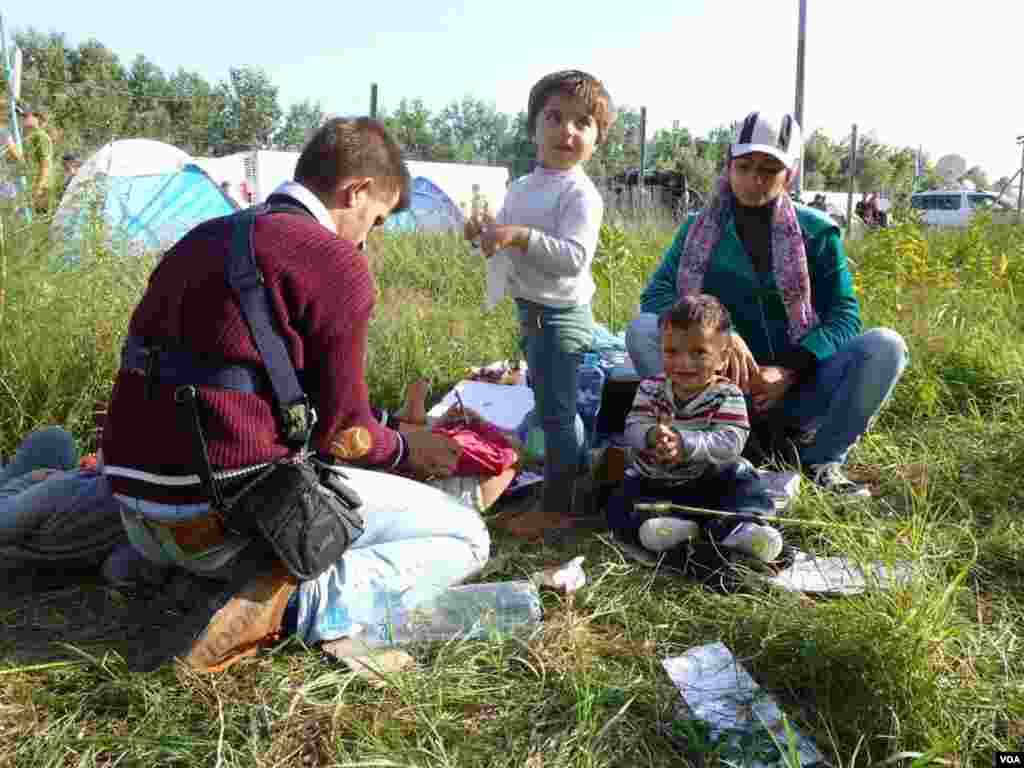 Thousands of migrants poured into Croatia on Thursday, setting up a new path toward Western Europe after Hungary used tear gas and water cannons to keep them out of its territory. Here, a Syrian refugee family takes a rest, at Horgos, Serbia, Sept. 15, 2015. (Henry Ridgwell/VOA)