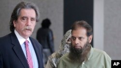 FILE - Shafi Khan, right, and Zarine Khan, parents of Mohammed Hamzah Khan, meet with the family's attorney, Thomas Dirkin, left, before Mohammed's detention hearing in federal court in Chicago, Oct. 9, 2014.