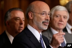 FILE - Pennsylvania Gov. Tom Wolf, center, discusses state budget negotiations at the state Capitol in Harrisburg, Pa., Oct. 7, 2015.