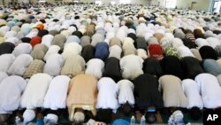 Muslims pray during Eid al Fitr prayer marking end of Ramadan in southern France, Aug. 19, 2012