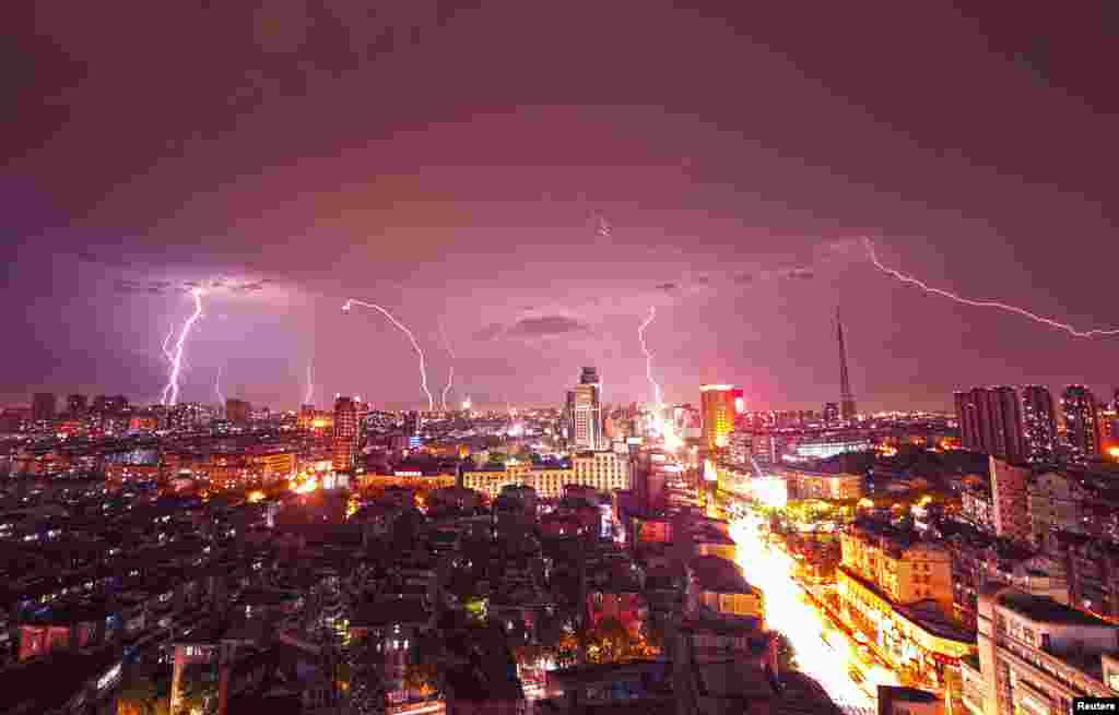 Lightning strikes over buildings during heavy rainfall in Kunshan, Jiangsu province, China, Sep. 2, 2014.