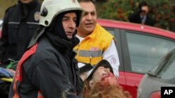 Medics carry an injured woman on a stretcher to an ambulance after a suspected suicide bomber detonated an explosive device at the entrance of the U.S. Embassy in the Turkish capital, Ankara, February 1, 2013. 