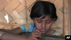 Sabina, 13, is forced to do textile work for her family's economic survival in Rashkali, India.