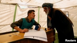 An Afghan man arrives at a voter registration center to register for the upcoming parliamentary and district council elections in Kabul, Afghanistan, April 23, 2018.