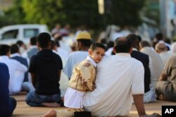 FILE - Worshipers attend a sermon during Eid al-Adha at the Martyrs Square in central Tripoli, Libya, -Sept. 24, 2015, in this photo by photographer and video journalist Mohamed Ben Khalifa, who was killed in Libya on Jan. 19, 2019.