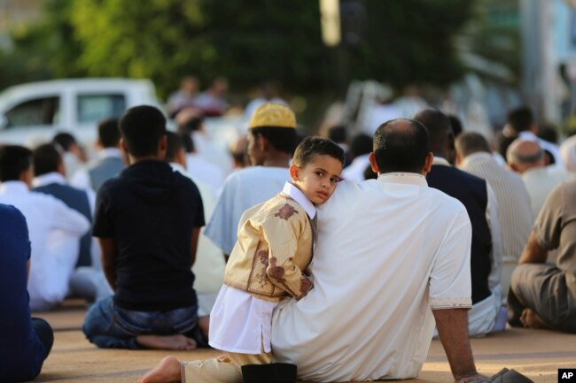 FILE - Worshipers attend a sermon during Eid al-Adha at the Martyrs Square in central Tripoli, Libya, -Sept. 24, 2015, in this photo by photographer and video journalist Mohamed Ben Khalifa, who was killed in Libya on Jan. 19, 2019.