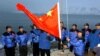 FILE - The Chinese national flag is raised in Longyearbyen on Svalbard, Norway, to set the site of a Chinese research station, Oct. 31, 2001. A new State Department report highlights the recent expansion of China's activities in the Arctic.